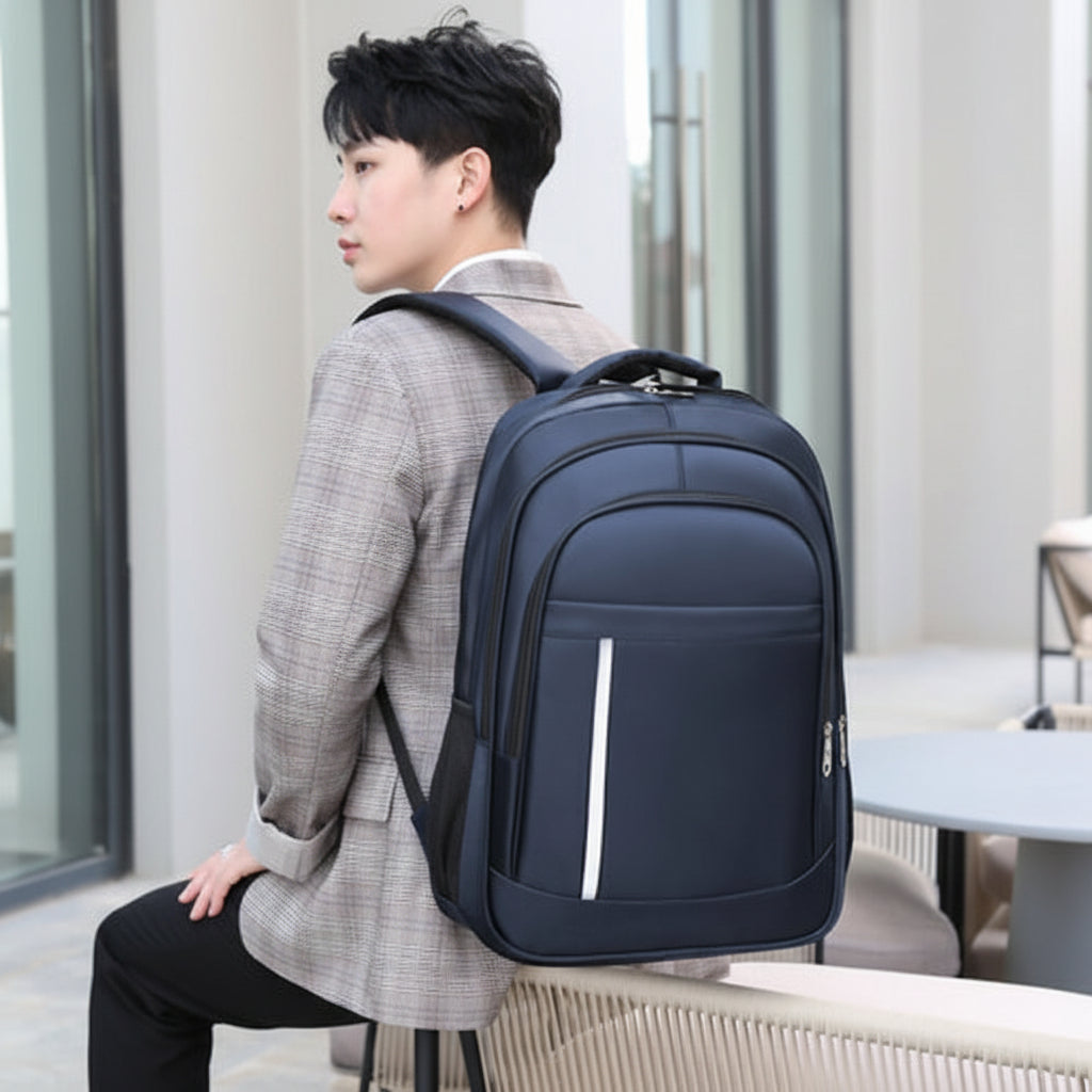 Person wearing a navy blue backpack in an outdoor setting