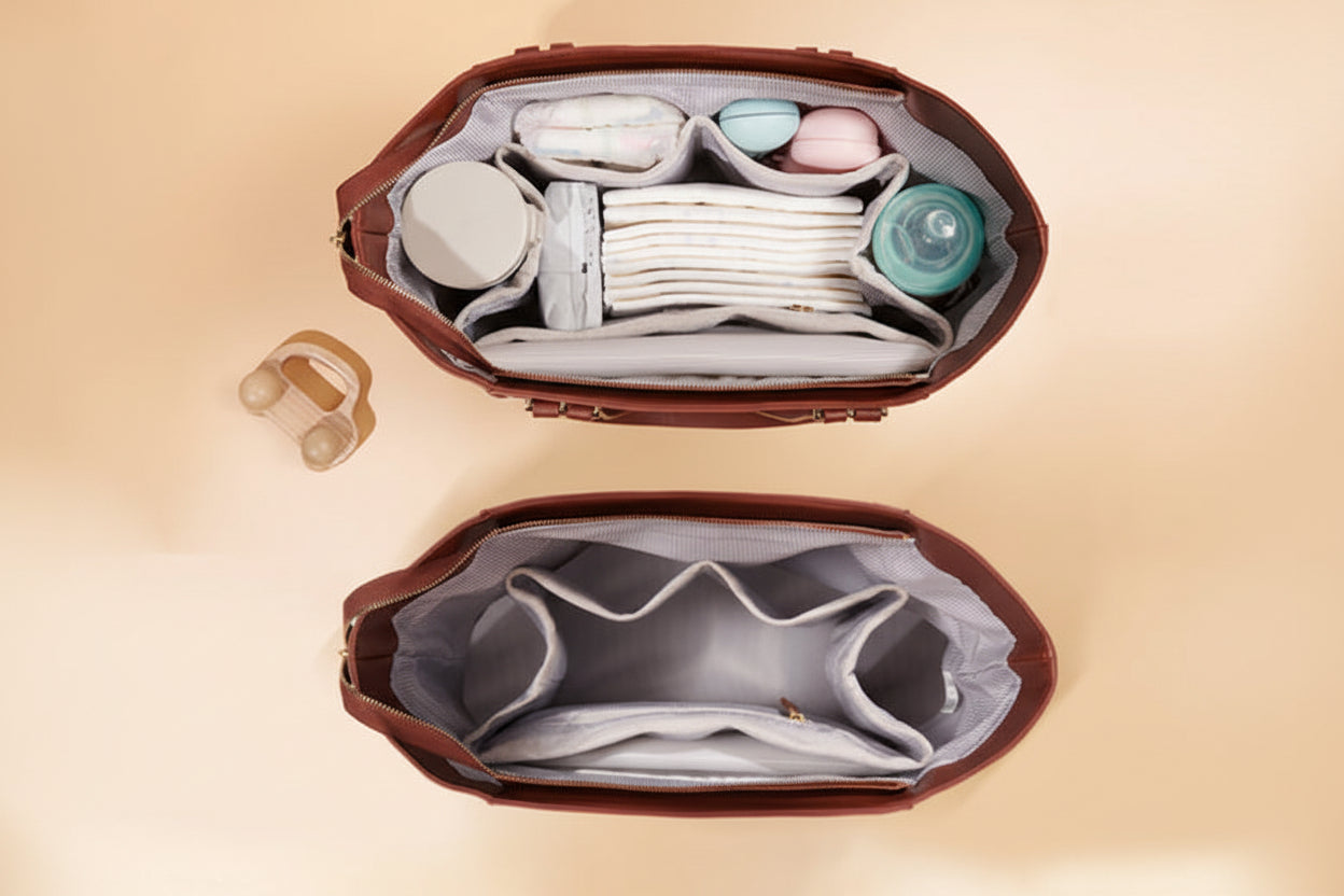 Open brown diaper bag with baby items on a beige background