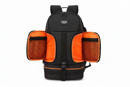 Black backpack with orange interior compartments on a white background