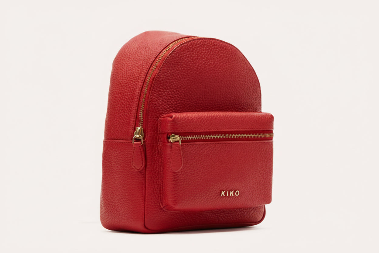 Red backpack with gold zipper and 'KIKO' branding on a light gray background