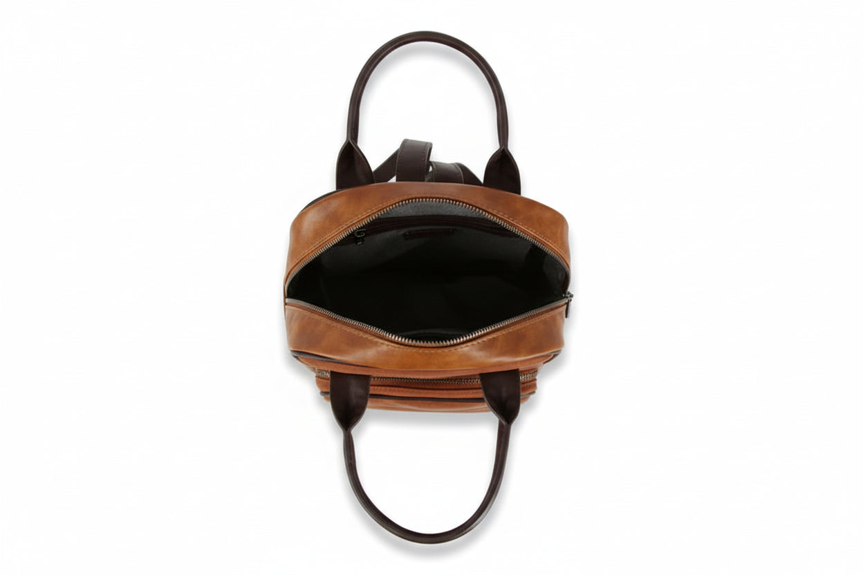 Brown leather backpack with black interior on a white background