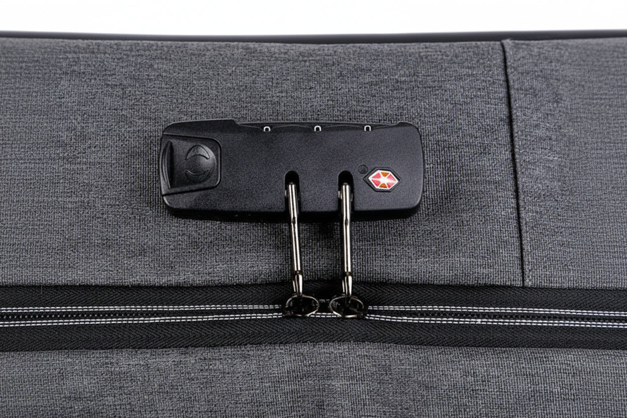 Close-up of a gray suitcase with a luggage tag attached on a white background