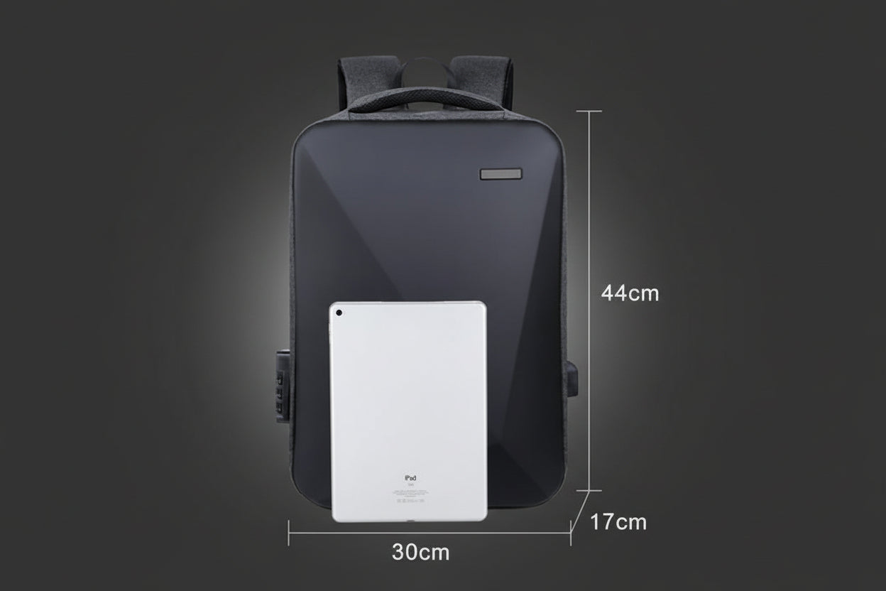 Black backpack with a white tablet for scale on a dark background