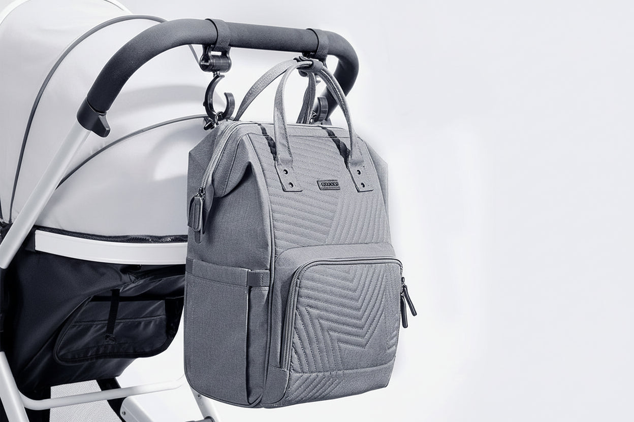 Gray quilted backpack attached to a stroller on a light gray background